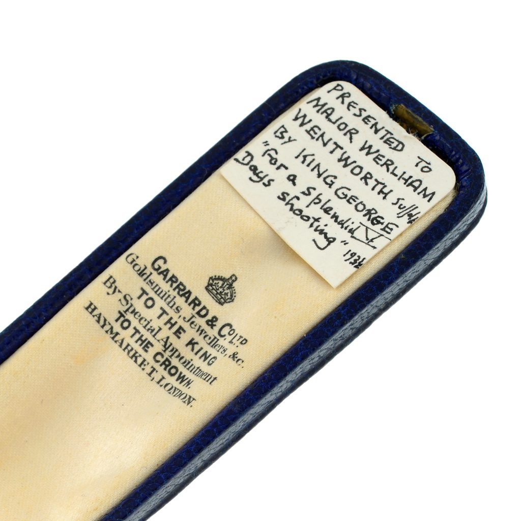 A box for a stick pin with a note reading: 'Presented to Major Werlham Wentworth [Suffolk] by King George V "for a splendid days shooting" 193[4]'.