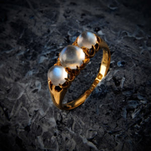 An Edwardian 18ct gold moonstone ring An Edwardian 18ct gold moonstone three-stone ring