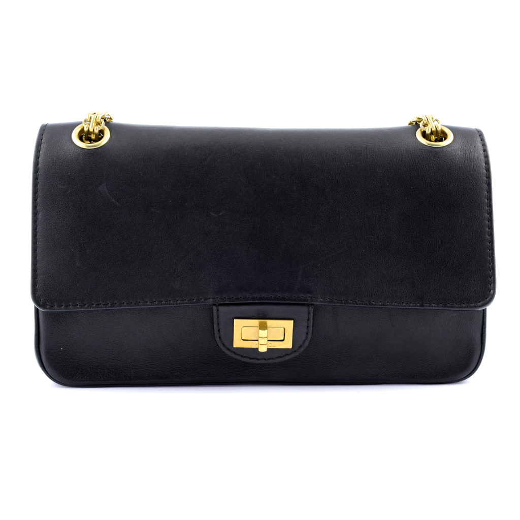 a special edition navy blue Chanel 2.55 Nude Medallion Reissue 225 handbag