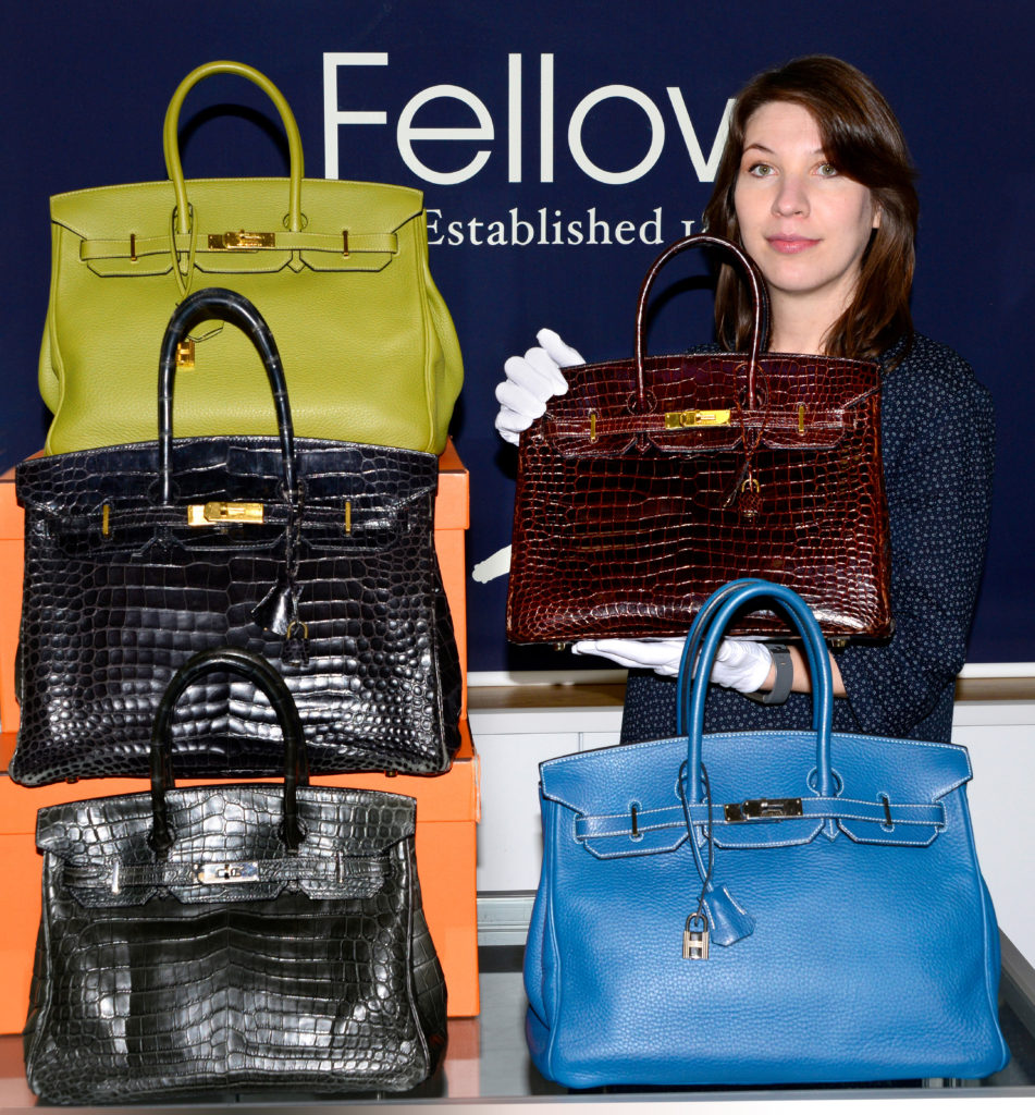 Designer Collection Specialist Sophie Higgs with the Birkin handbags which flew above their estimates