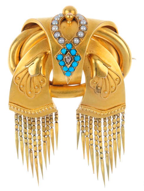 A late Victorian Etruscan Revival gold and gem-set brooch.