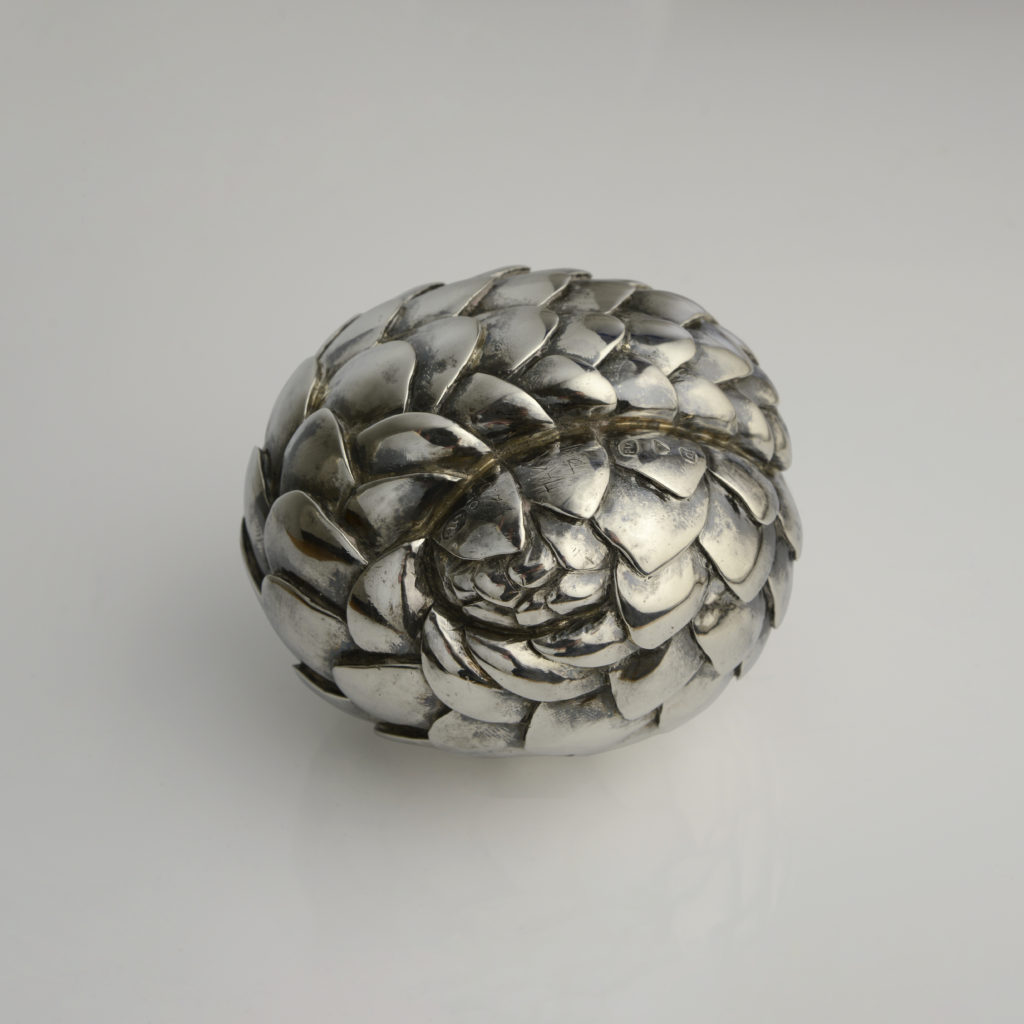 Rolled Pangolin silver sculpture, by Patrick Mavros.