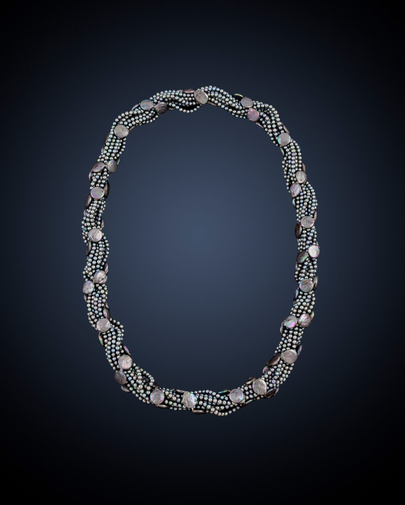 Grey cultured pearl multi-row intertwined necklace, modelled by April Ashley